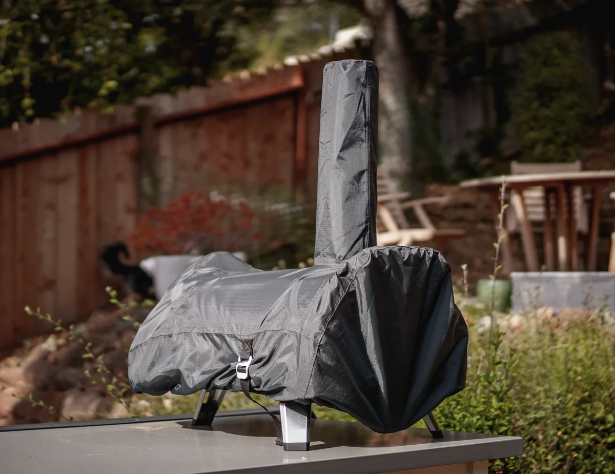 My Ooni pizza oven neatly stored with the optional cover.